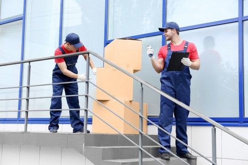 Professional movers handling office equipment in Holloway